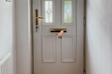 elora viano _ hand through door